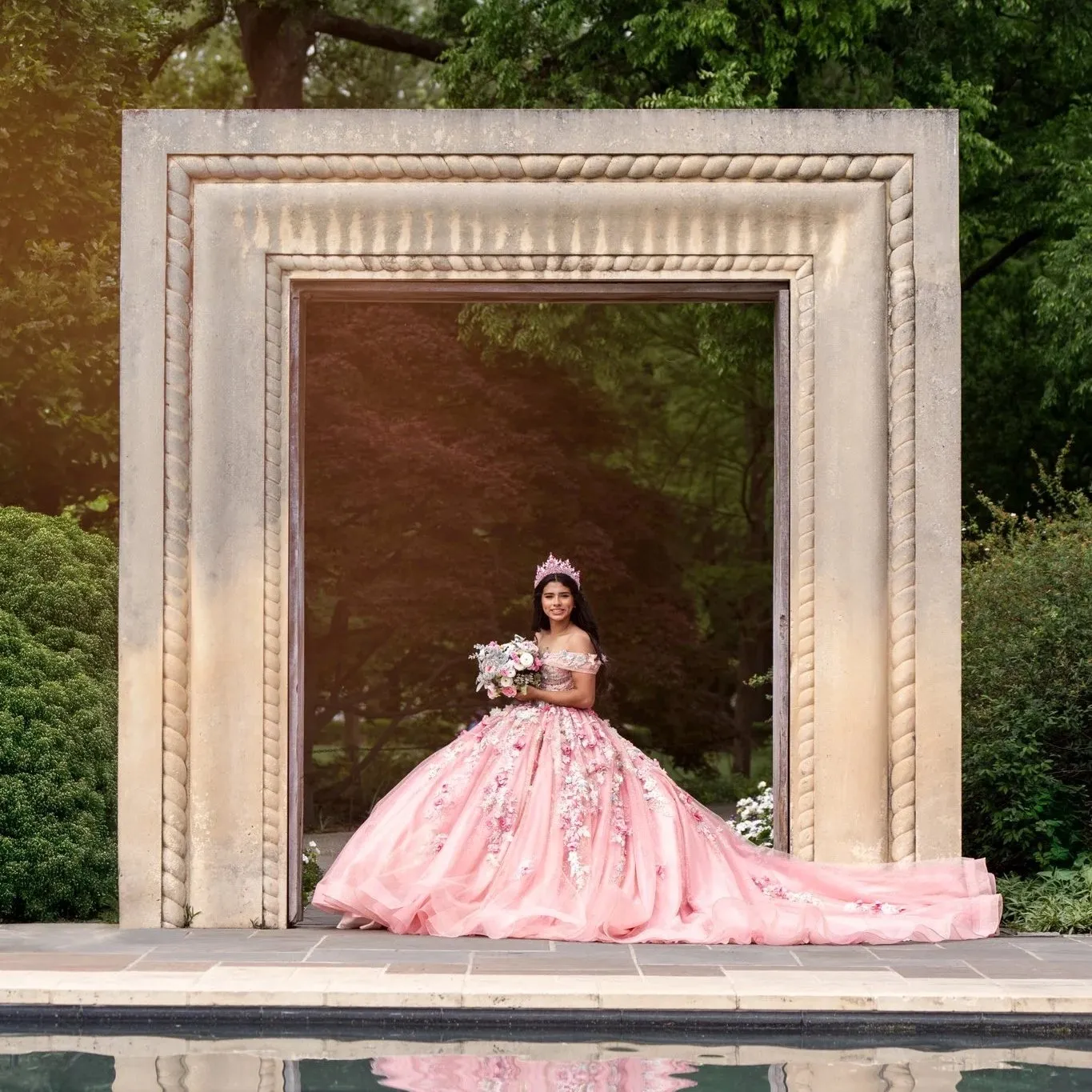Quinceañera in an elegant gown posing for her XV portraits in Dallas